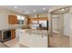 Open kitchen with granite countertops, an island, wood cabinets, and modern stainless steel appliances at 5861 Lakeland Village Dr, North Las Vegas, NV 89081