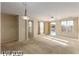 Open-concept living and dining area with neutral walls and carpet flooring at 5861 Lakeland Village Dr, North Las Vegas, NV 89081