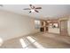 Open-concept living area leading to a kitchen with wood cabinets and breakfast bar at 5861 Lakeland Village Dr, North Las Vegas, NV 89081