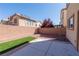 Backyard with a brick wall, artificial turf, gravel and a concrete patio at 6036 Sierra Lakes St, North Las Vegas, NV 89031