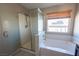 Serene bathroom boasts a soaking tub, separate shower, and a window offering ample natural light at 6036 Sierra Lakes St, North Las Vegas, NV 89031