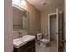Bright bathroom with vanity and tiled floor, toilet room in the back at 6036 Sierra Lakes St, North Las Vegas, NV 89031