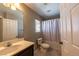 Bathroom with a single sink vanity, a tub/shower combo with curtain and tile flooring at 6036 Sierra Lakes St, North Las Vegas, NV 89031