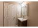 Neutral bathroom with vanity, mirror, and wood-look drawers at 6036 Sierra Lakes St, North Las Vegas, NV 89031