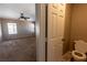Inviting bedroom and bathroom features neutral walls, ceiling fan, and plush carpeting at 6036 Sierra Lakes St, North Las Vegas, NV 89031