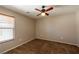 Bedroom features neutral walls, carpeted flooring, and a ceiling fan with lighting at 6036 Sierra Lakes St, North Las Vegas, NV 89031