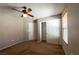 Bedroom features neutral walls, carpeted flooring, and a ceiling fan with lighting at 6036 Sierra Lakes St, North Las Vegas, NV 89031