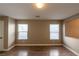 Well-lit dining room with wood flooring and two windows at 6036 Sierra Lakes St, North Las Vegas, NV 89031