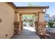 Covered porch with stone-clad pillars and a view of the neighborhood at 6036 Sierra Lakes St, North Las Vegas, NV 89031