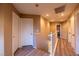 Well-lit hallway with wood-look flooring and white doors offers a clean and inviting transition between rooms at 6036 Sierra Lakes St, North Las Vegas, NV 89031