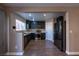 Open concept kitchen has stainless steel appliances and dark cabinets at 6036 Sierra Lakes St, North Las Vegas, NV 89031