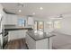 Modern kitchen with stainless steel appliances, a center island, and access to the yard at 6215 Blood Lily Ave, Las Vegas, NV 89122
