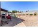 Backyard patio with furniture, grill, rock landscaping, and pool in the background at 6320 Peppermill Dr, Las Vegas, NV 89146