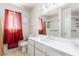 Bright bathroom with a white vanity, tile floors, and a shower-tub combo at 6320 Peppermill Dr, Las Vegas, NV 89146