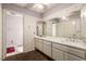 Neutral bathroom with double sinks, a long vanity, a large mirror, and tile flooring at 6320 Peppermill Dr, Las Vegas, NV 89146