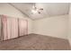 Spacious bedroom featuring neutral walls, a ceiling fan and plush carpeting throughout at 6320 Peppermill Dr, Las Vegas, NV 89146