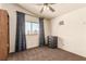 Bedroom with a ceiling fan and a window view and neutral brown carpet at 6320 Peppermill Dr, Las Vegas, NV 89146