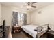 Small bedroom featuring neutral paint, a window, carpet and a ceiling fan at 6320 Peppermill Dr, Las Vegas, NV 89146