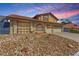 Two-story home featuring a tile roof, rock landscaping, and a two-car garage, enhancing curb appeal at 6320 Peppermill Dr, Las Vegas, NV 89146