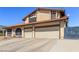 Exterior featuring a three-car garage, desert landscaping, and long driveway at 6320 Peppermill Dr, Las Vegas, NV 89146