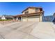 Front exterior view of home with a three-car garage and long driveway at 6320 Peppermill Dr, Las Vegas, NV 89146