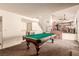 Open-concept game room with a billiard table, adjacent to stairs, and living area at 6320 Peppermill Dr, Las Vegas, NV 89146