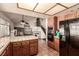 Open kitchen with tiled countertops, breakfast bar, and views of the living area at 6320 Peppermill Dr, Las Vegas, NV 89146