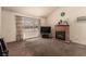 Spacious living room featuring a fireplace, a vaulted ceiling, and a large window at 6320 Peppermill Dr, Las Vegas, NV 89146