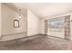 Bright living room featuring neutral walls, carpet, and a large window at 6320 Peppermill Dr, Las Vegas, NV 89146