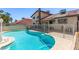 Backyard pool and patio area with a white fence at 6320 Peppermill Dr, Las Vegas, NV 89146