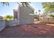 Backyard featuring a neutral stucco wall and covered patio with a bare landscape at 6628 Silver Penny Ave, Las Vegas, NV 89108