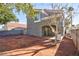 Backyard featuring a neutral stucco wall and covered patio with a bare landscape at 6628 Silver Penny Ave, Las Vegas, NV 89108