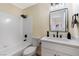 Neat bathroom featuring a shower-tub combo, a stylish vanity, and modern black fixtures at 6628 Silver Penny Ave, Las Vegas, NV 89108