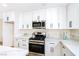 Modern kitchen with white cabinets, stainless steel appliances, gas range, and sleek countertops, creating a chef's dream at 6628 Silver Penny Ave, Las Vegas, NV 89108