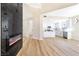 Open-concept living room and kitchen with white cabinets, island, and stainless steel appliances at 6628 Silver Penny Ave, Las Vegas, NV 89108