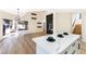 Open concept living space with a kitchen island, fireplace, and modern chandelier, perfect for entertaining and daily living at 6628 Silver Penny Ave, Las Vegas, NV 89108