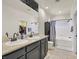 Bathroom with double vanity, granite countertop, a bath tub and shower, and a closet at 748 Canfield Point Ave, Las Vegas, NV 89183