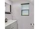 Clean bathroom featuring a single vanity, window, and modern fixtures in a neutral color palette at 748 Canfield Point Ave, Las Vegas, NV 89183