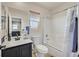 Bright bathroom featuring a tub and shower combo, vanity with black cabinets, and a large mirror at 748 Canfield Point Ave, Las Vegas, NV 89183
