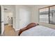 Cozy bedroom featuring a sliding closet door, a window with blinds, and wood-look flooring at 748 Canfield Point Ave, Las Vegas, NV 89183