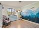 bedroom with a charming mountain mural, rocking chair, and wood-look flooring at 748 Canfield Point Ave, Las Vegas, NV 89183