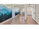 bedroom featuring a mountain mural, mirrored closet doors and doorway to another room at 748 Canfield Point Ave, Las Vegas, NV 89183