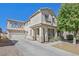 Charming two-story home features a covered porch, attached garage, and a well-manicured front yard at 748 Canfield Point Ave, Las Vegas, NV 89183