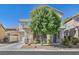 Two-story home featuring stucco siding, a covered porch, desert landscaping, and an attached garage at 748 Canfield Point Ave, Las Vegas, NV 89183