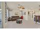 Comfortable living room with a leather sofa, ceiling fan, modern decor, and access to the outside patio at 748 Canfield Point Ave, Las Vegas, NV 89183