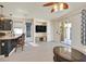 Bright and airy living room featuring a ceiling fan, TV, and sliding glass doors to the patio at 748 Canfield Point Ave, Las Vegas, NV 89183