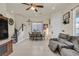 Open-concept living space featuring hardwood floors, comfortable seating, and a staircase leading to upper level at 748 Canfield Point Ave, Las Vegas, NV 89183