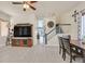 Spacious living room with hardwood floors, large TV, and open access to the dining and kitchen areas at 748 Canfield Point Ave, Las Vegas, NV 89183