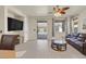 Bright living room features hardwood floors, a sliding glass door to the pool area, and comfortable seating at 748 Canfield Point Ave, Las Vegas, NV 89183