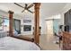Spacious main bedroom with an elegant four-poster bed, fireplace, a ceiling fan, and an ensuite bathroom at 748 Canfield Point Ave, Las Vegas, NV 89183